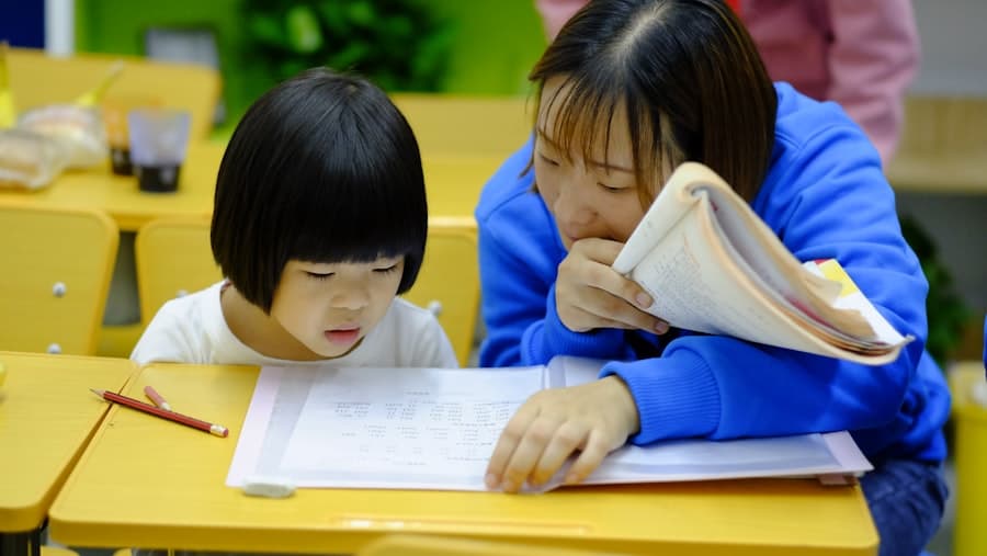 A therapist working one-on-one with a child at a desk
